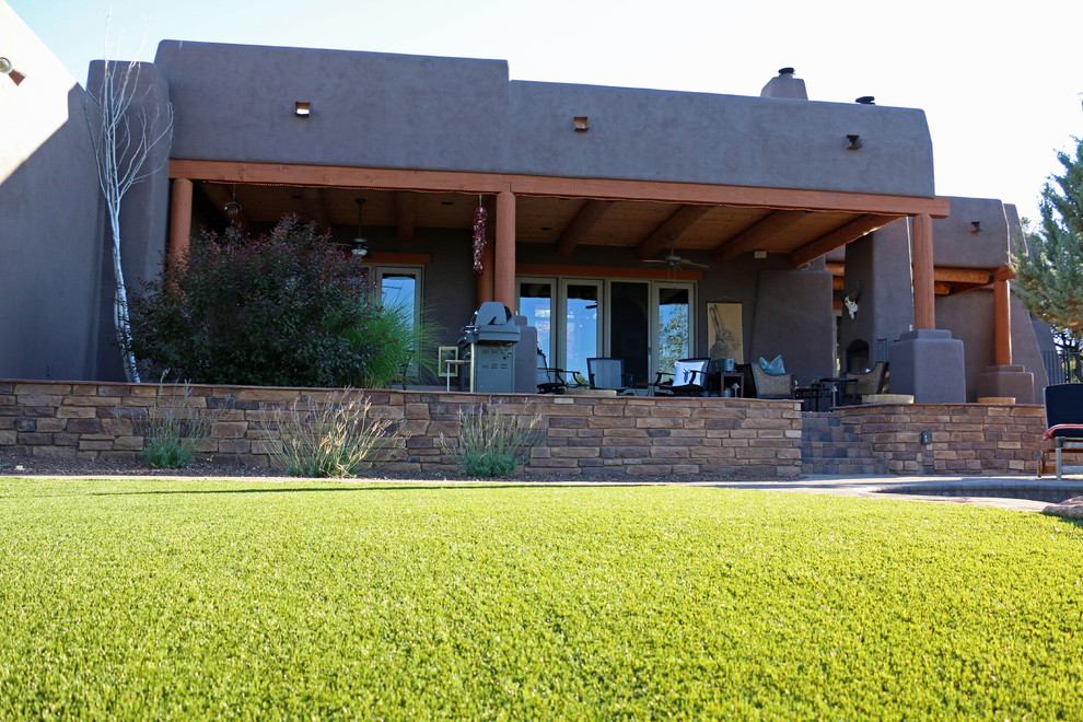 Photo of a large back custom shaped swimming pool in Phoenix with a water feature and brick paving.