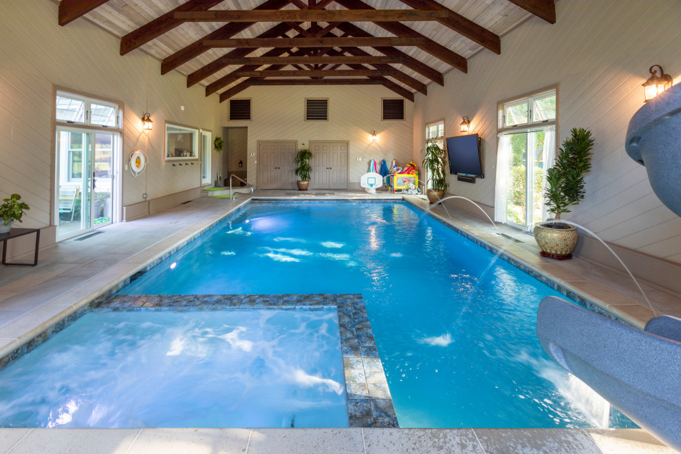 Imagen de casa de la piscina y piscina alargada tradicional de tamaño medio interior y rectangular con adoquines de piedra natural