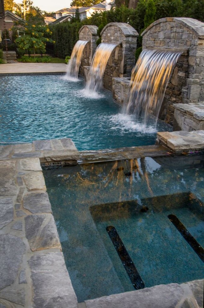 Large trendy backyard concrete paver and rectangular lap pool fountain photo in Tampa