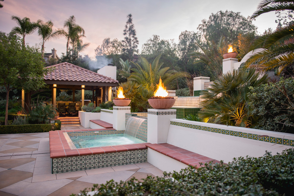 Large tuscan backyard concrete and rectangular lap pool fountain photo in Los Angeles