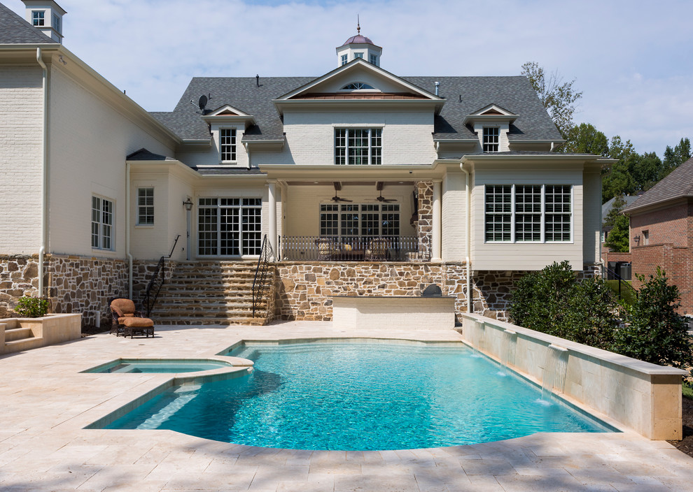 Inspiration for a timeless backyard stone and custom-shaped pool fountain remodel in Charlotte