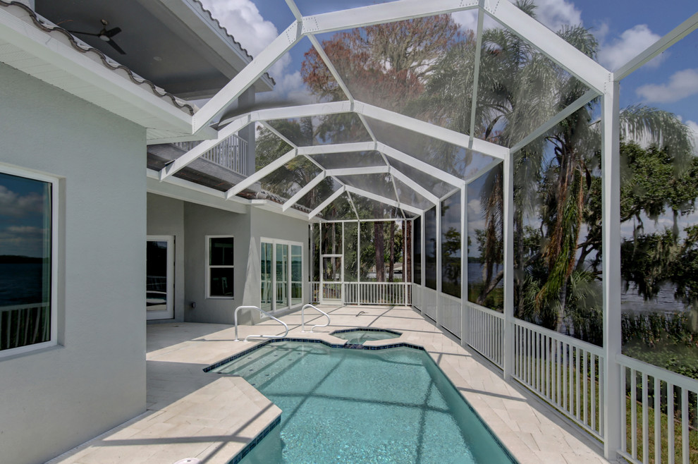 Pool - large coastal backyard stone and custom-shaped pool idea in Tampa