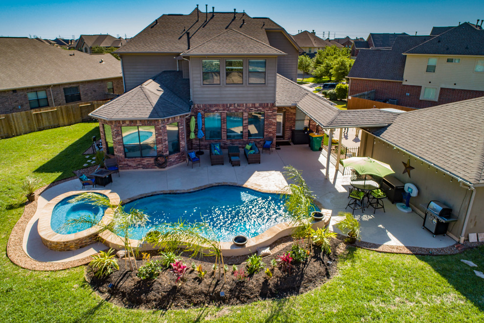 Pool - mid-sized traditional backyard custom-shaped pool idea in Houston with decking