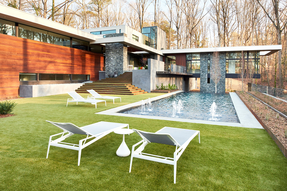 Pool fountain - huge contemporary backyard concrete paver and rectangular infinity pool fountain idea in Atlanta