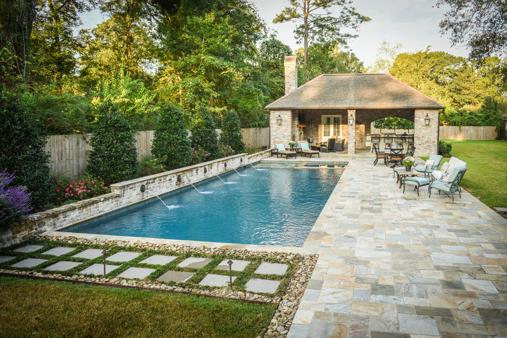 This is an example of a classic back rectangular swimming pool in New Orleans with a bar area.