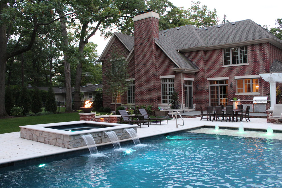 Photo of a traditional rectangular swimming pool in Chicago with a bbq area and a shelter.