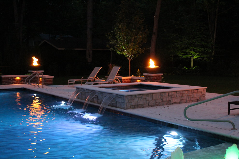 Inspiration for a large timeless backyard rectangular pool fountain remodel in Chicago
