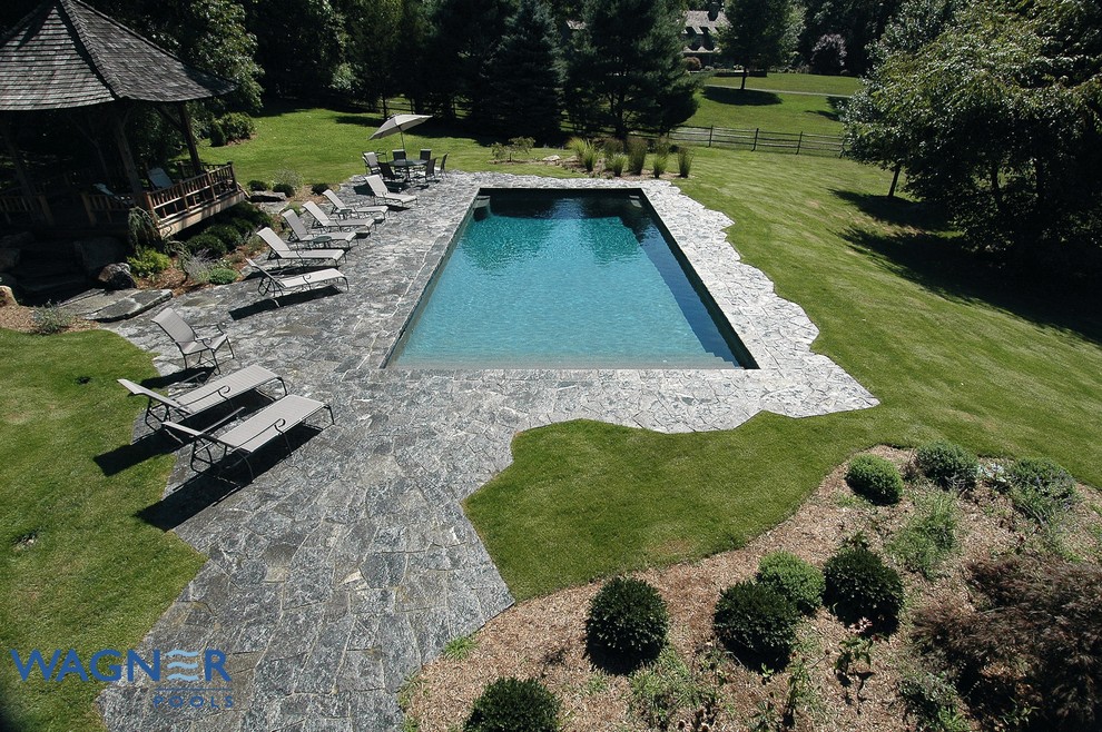 Large elegant backyard rectangular and stone lap pool fountain photo in New York