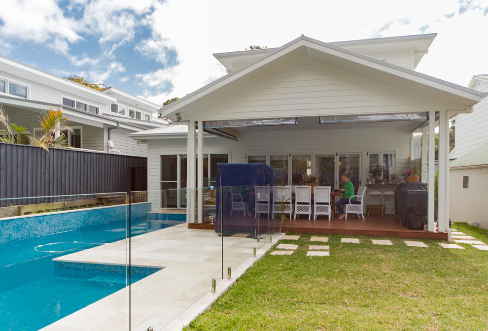 Design ideas for a coastal back lengths swimming pool in Sydney with tiled flooring.