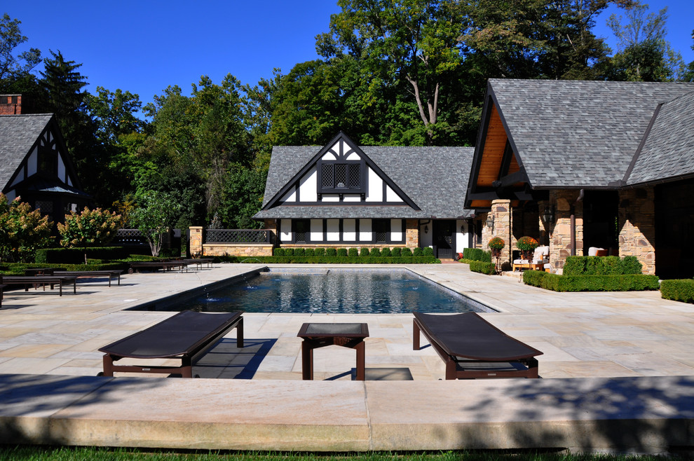 Inspiration for a large timeless backyard stone and rectangular pool fountain remodel in Cleveland