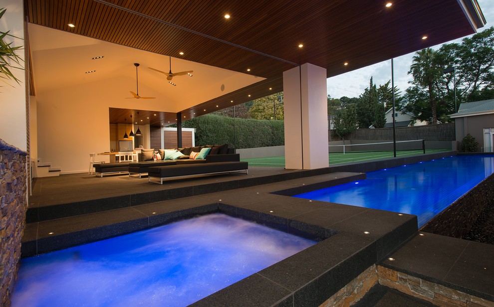 Example of a large minimalist backyard rectangular infinity pool design in Adelaide