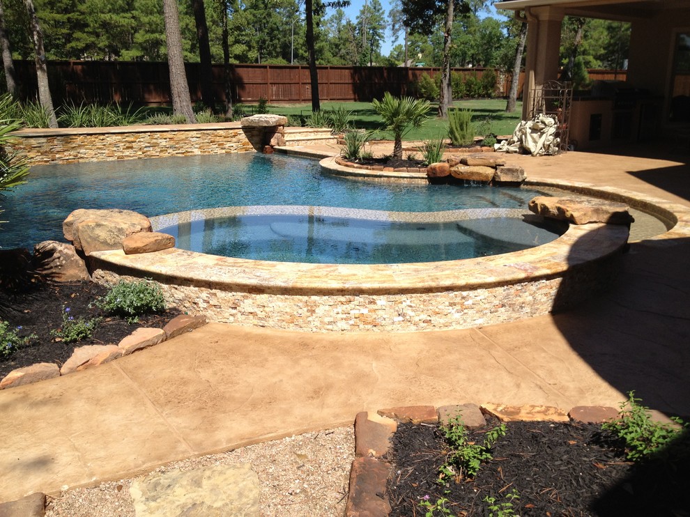 Inspiration for a large mediterranean backyard custom-shaped pool remodel in Houston