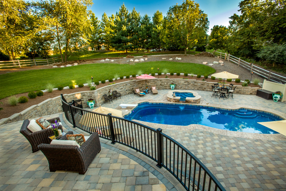 Huge transitional backyard stone and custom-shaped natural hot tub photo in Cincinnati