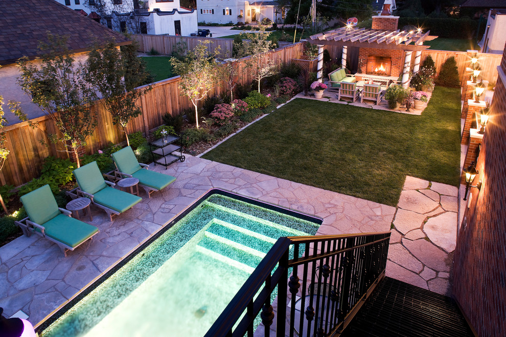 Cette photo montre une piscine latérale chic de taille moyenne et rectangle avec un point d'eau et des pavés en pierre naturelle.