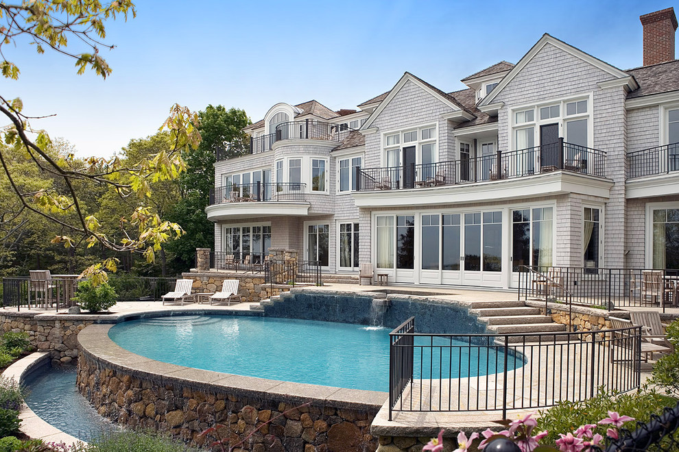 Inspiration for a mid-sized timeless backyard stone and custom-shaped pool fountain remodel in Boston