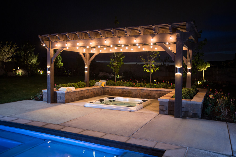 Inspiration for a large contemporary back rectangular lengths hot tub in Salt Lake City with concrete paving.