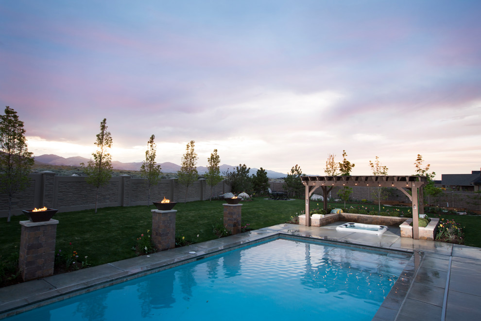 Inspiration for a large traditional back rectangular lengths hot tub in Salt Lake City with concrete paving.