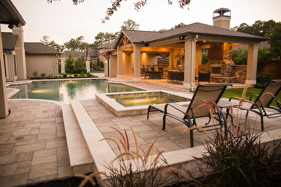 Inspiration for a large classic back custom shaped lengths swimming pool in Houston with a pool house and stamped concrete.
