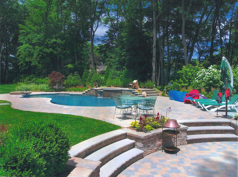 Идея дизайна: бассейн среднего размера, произвольной формы на заднем дворе в морском стиле с джакузи и мощением тротуарной плиткой