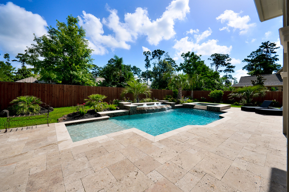 This is an example of a large mediterranean back custom shaped hot tub in Houston with natural stone paving.