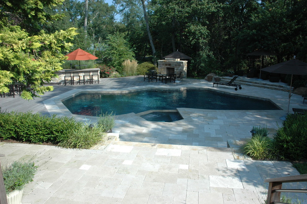 Mid-sized trendy backyard stone and custom-shaped pool landscaping photo in New York