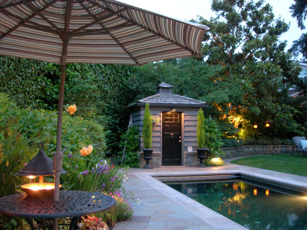 Inspiration for a large traditional back rectangular lengths swimming pool in Seattle with a pool house and natural stone paving.