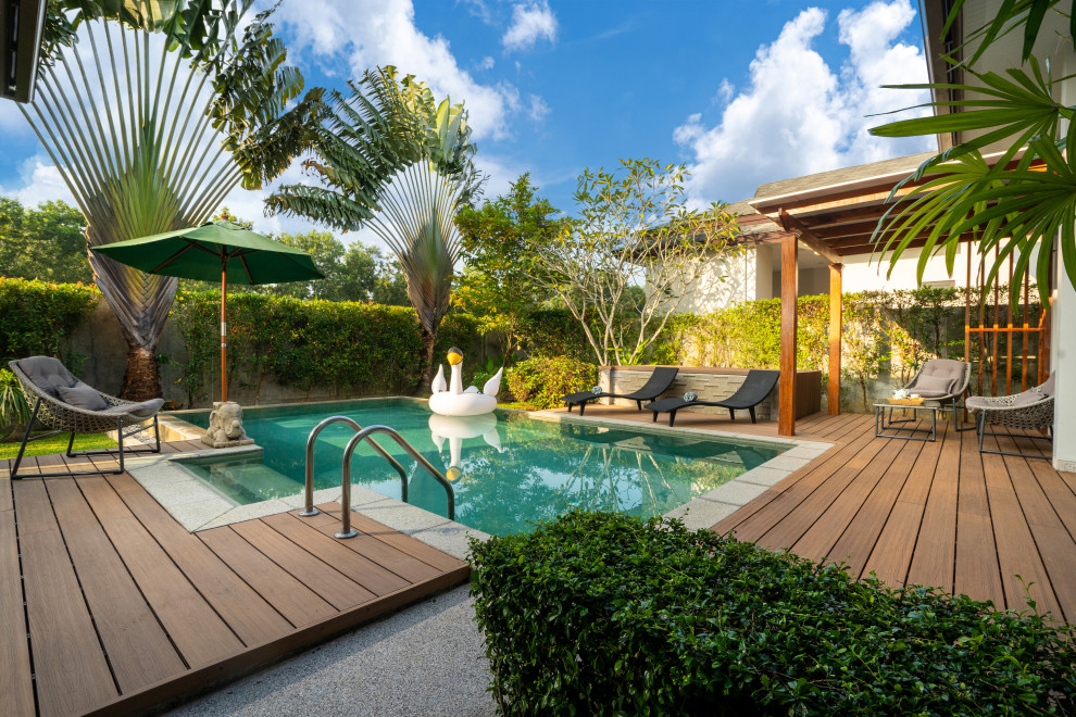 Inspiration for a contemporary rectangular pool remodel in Miami with decking