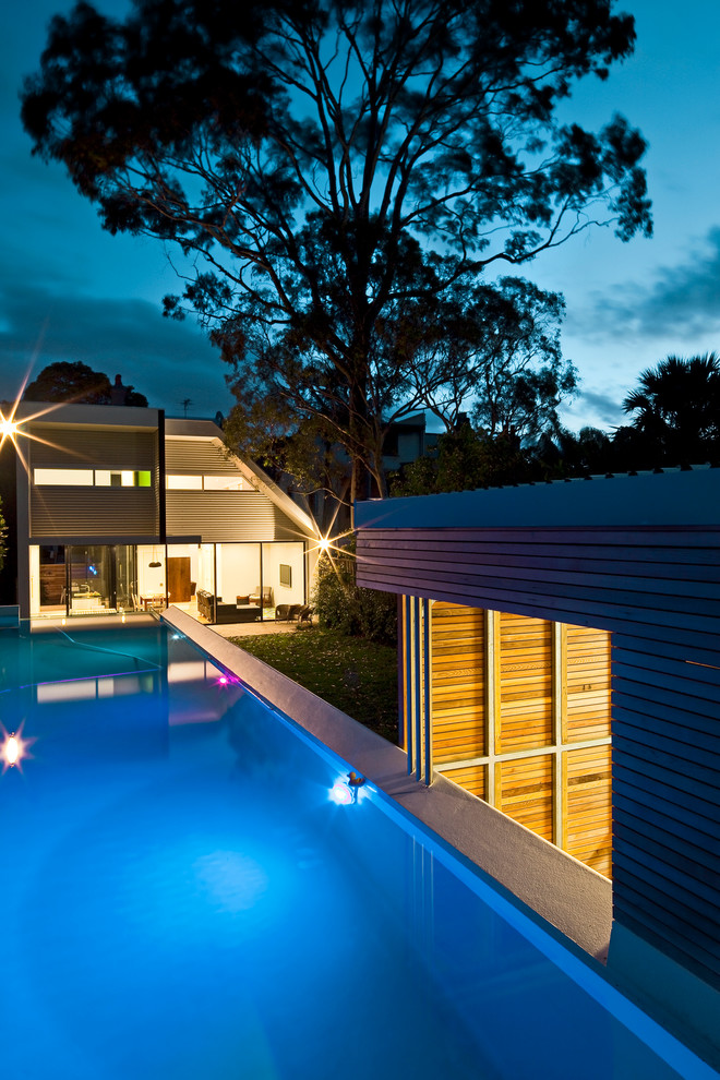 Design ideas for a large contemporary back rectangular lengths swimming pool in Sydney.