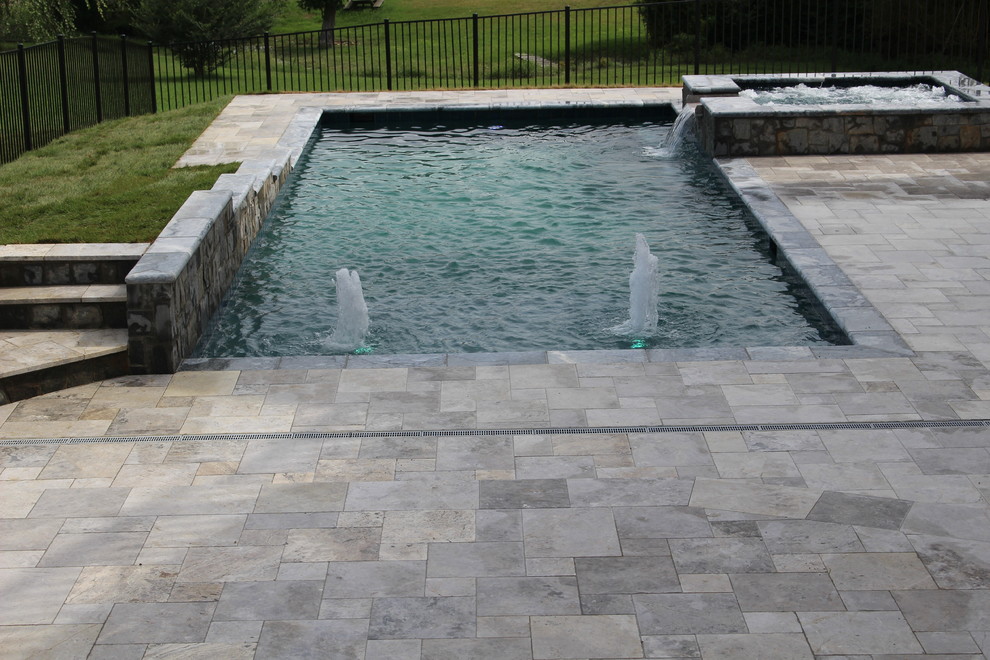 Esempio di una piccola piscina naturale rustica rettangolare dietro casa con una vasca idromassaggio e pavimentazioni in pietra naturale