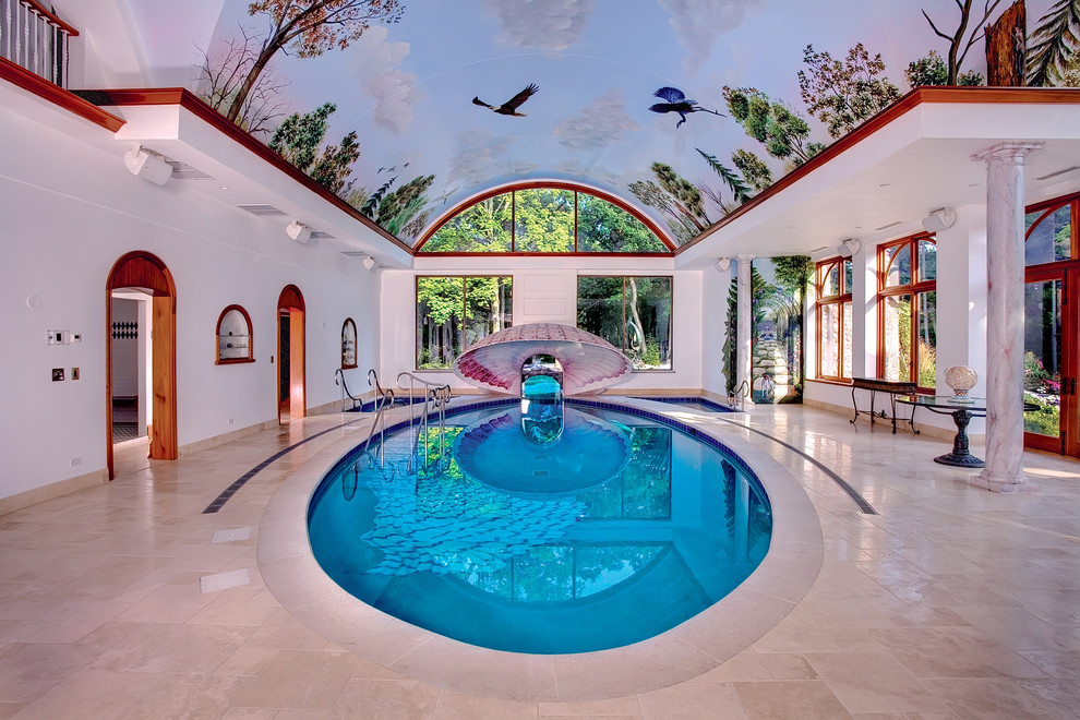 Réalisation d'une très grande piscine intérieure méditerranéenne sur mesure avec des pavés en pierre naturelle et un bain bouillonnant.