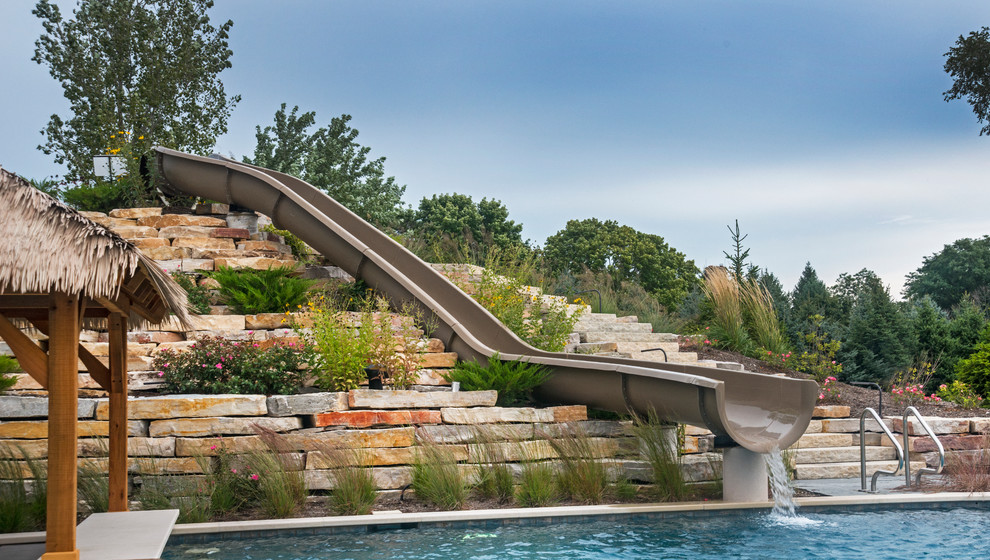 Huge island style backyard stone and custom-shaped lap water slide photo in Chicago