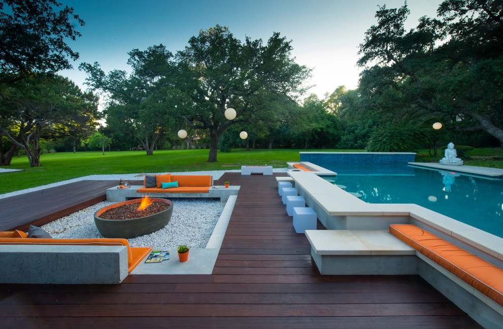 Trendy backyard custom-shaped pool photo in Austin with decking