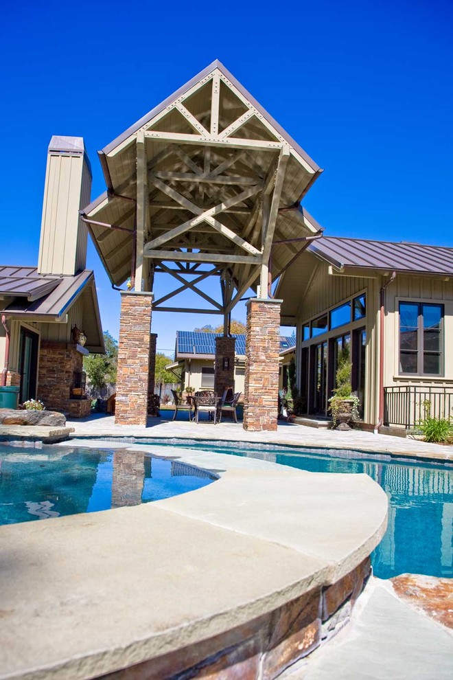 Cette photo montre un grand Abris de piscine et pool houses arrière nature en forme de haricot avec des pavés en pierre naturelle.