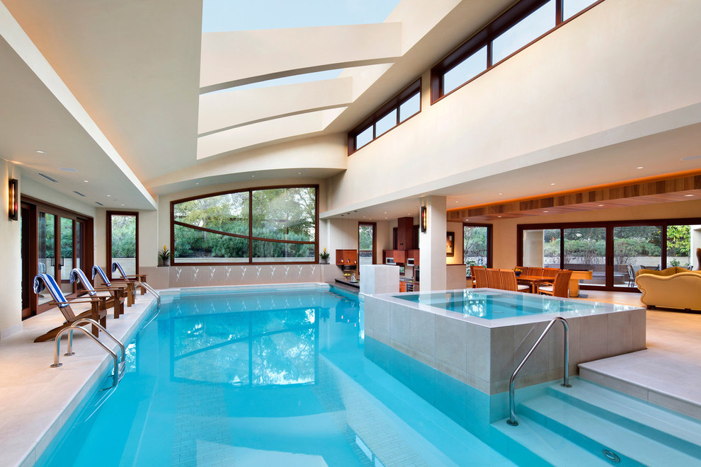 Contemporary indoor rectangular swimming pool in San Francisco with tiled flooring and a bar area.