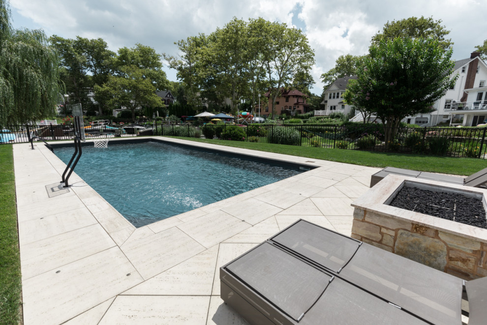 Ispirazione per una piscina monocorsia chic rettangolare di medie dimensioni e dietro casa con pavimentazioni in cemento