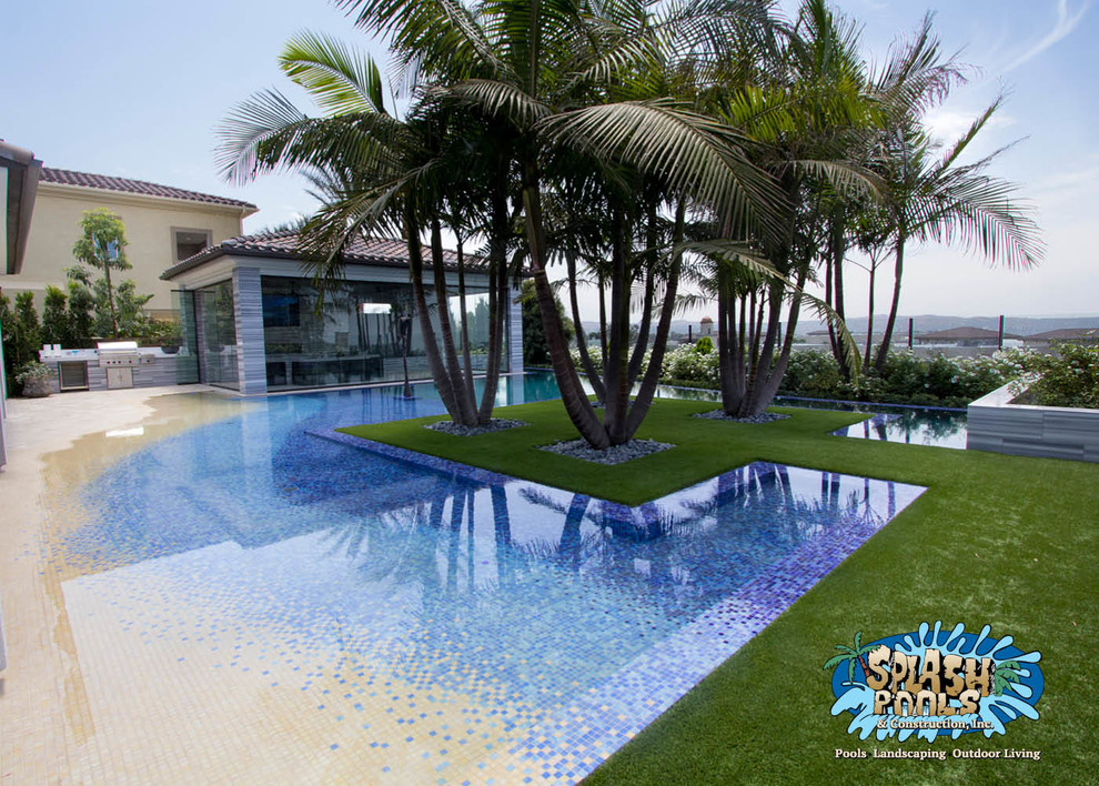Inspiration for a large nautical back custom shaped swimming pool in Orange County with a water feature and tiled flooring.