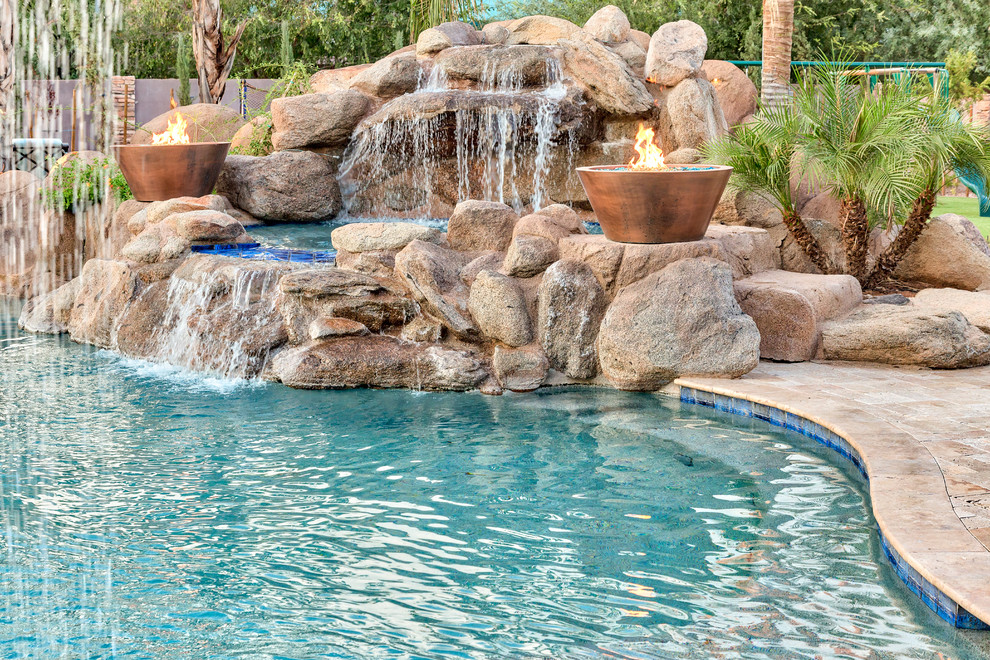 Inspiration for a large mediterranean backyard stone natural pool remodel in Phoenix