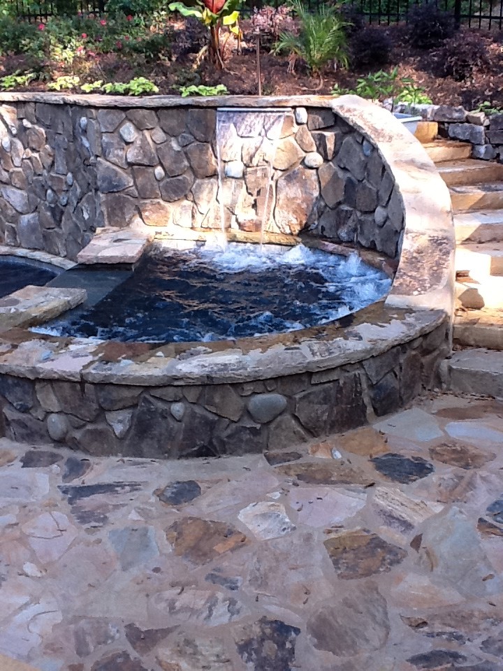 Hot tub - mid-sized traditional backyard stone and kidney-shaped natural hot tub idea in Atlanta