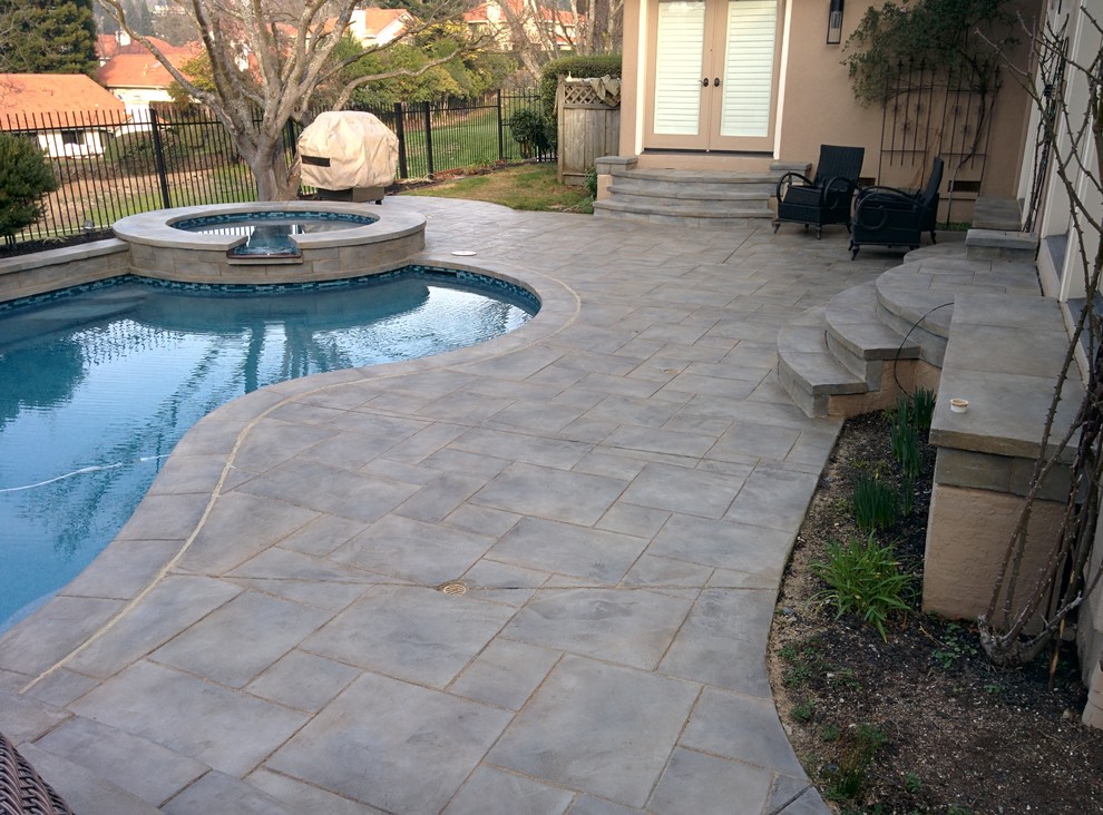 Example of a large arts and crafts backyard custom-shaped and stamped concrete natural pool design in San Francisco