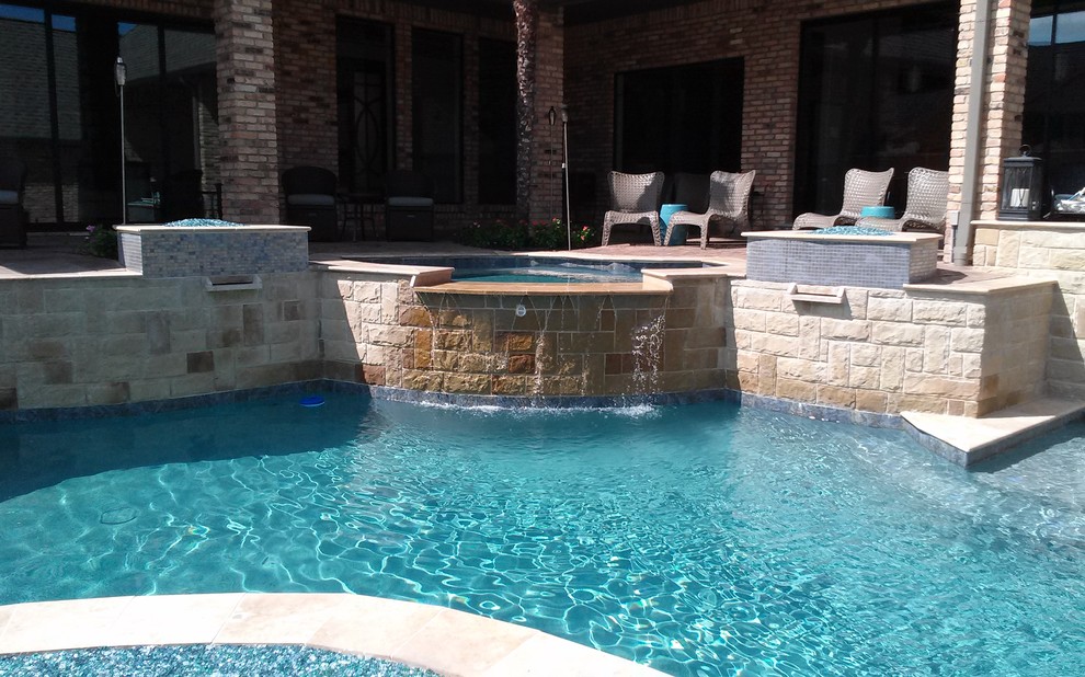 This is an example of a medium sized modern back custom shaped natural swimming pool in Dallas with natural stone paving.