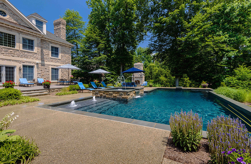 Inspiration for a large timeless backyard custom-shaped and concrete lap pool fountain remodel in Baltimore