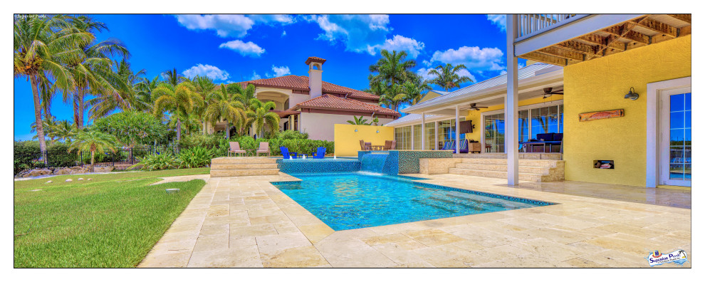 Inspiration for an expansive modern courtyard custom shaped lengths swimming pool in Tampa with a pool house and natural stone paving.