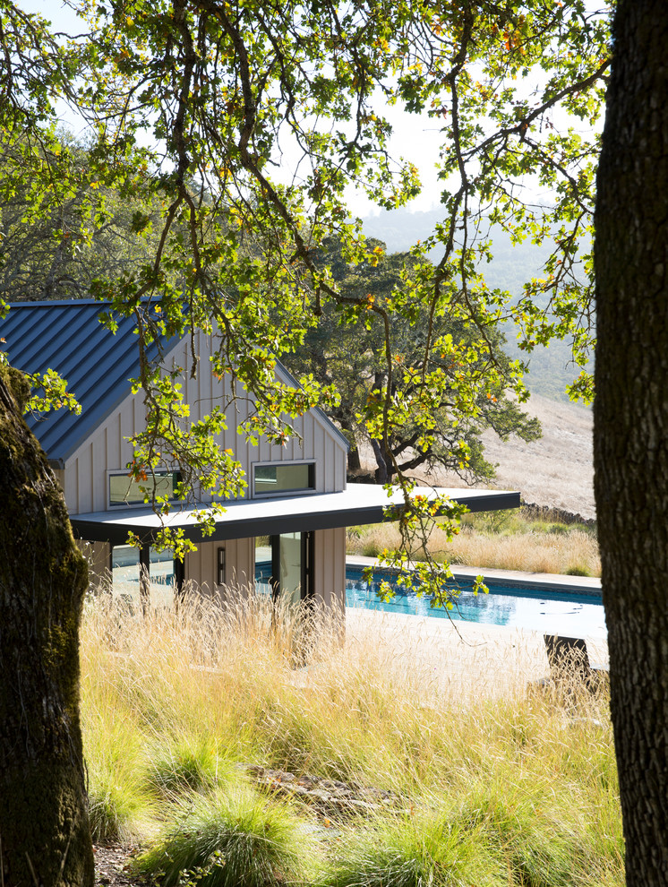 Photo of a small rural back rectangular lengths swimming pool in San Luis Obispo with a pool house and decking.