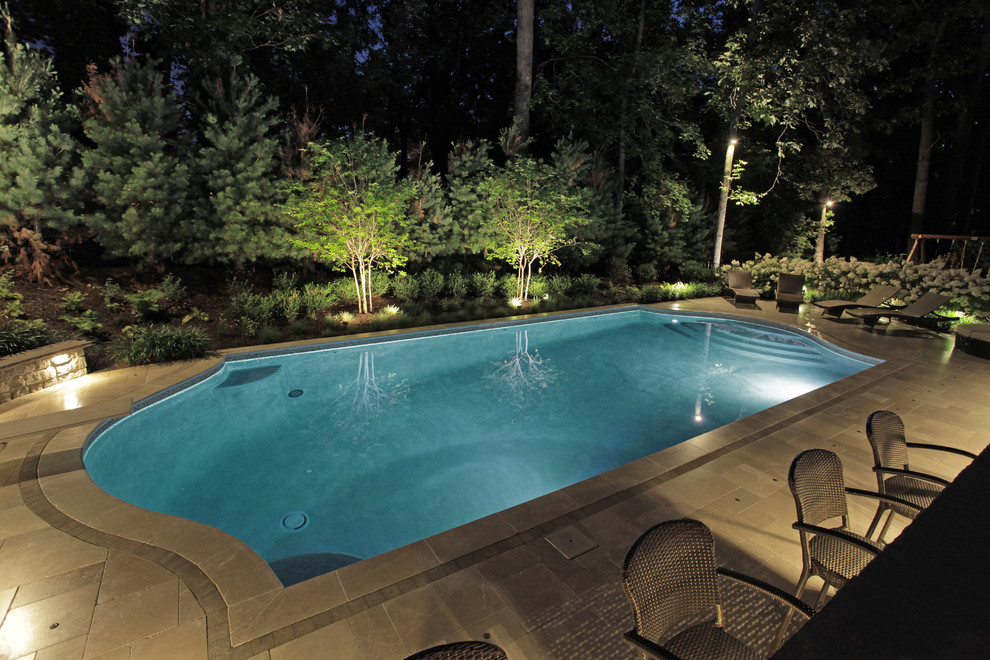 Design ideas for an expansive classic back custom shaped lengths swimming pool in New York with tiled flooring.
