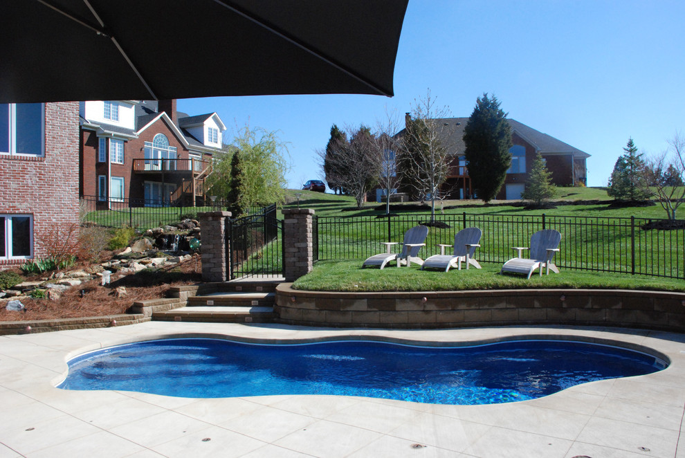 Design ideas for a medium sized contemporary back custom shaped swimming pool in Louisville with concrete paving.