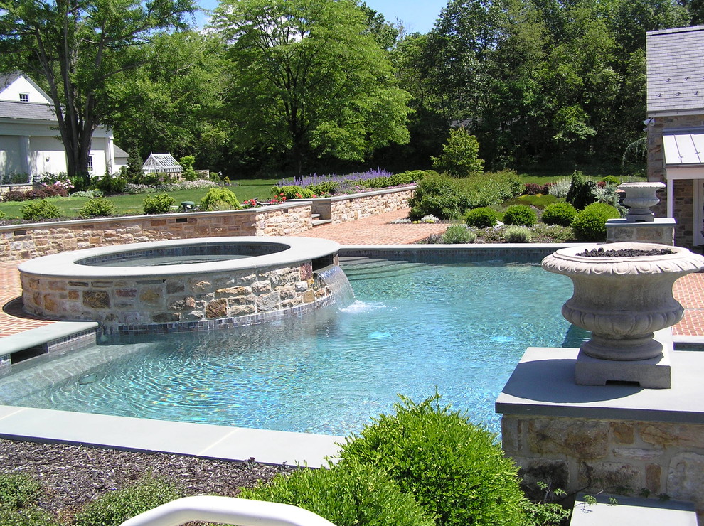 Large elegant backyard brick and custom-shaped lap hot tub photo in Philadelphia