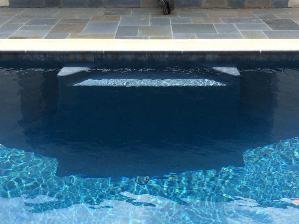 Elegant backyard stone and rectangular lap pool fountain photo in Philadelphia