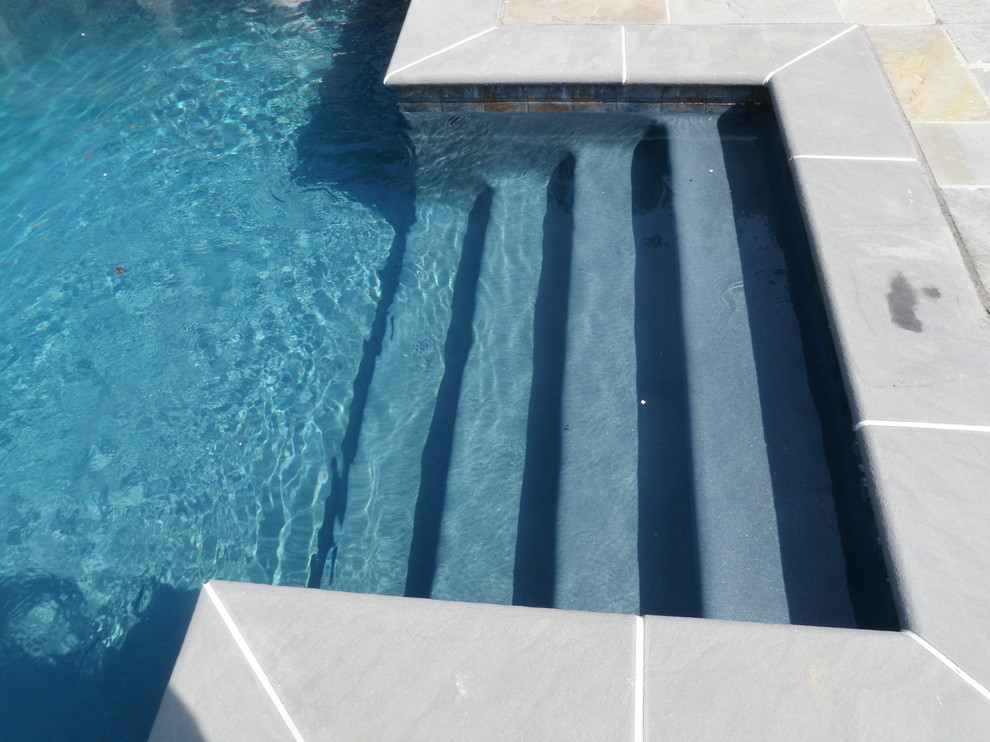 Elegant backyard stone and rectangular lap pool fountain photo in Philadelphia