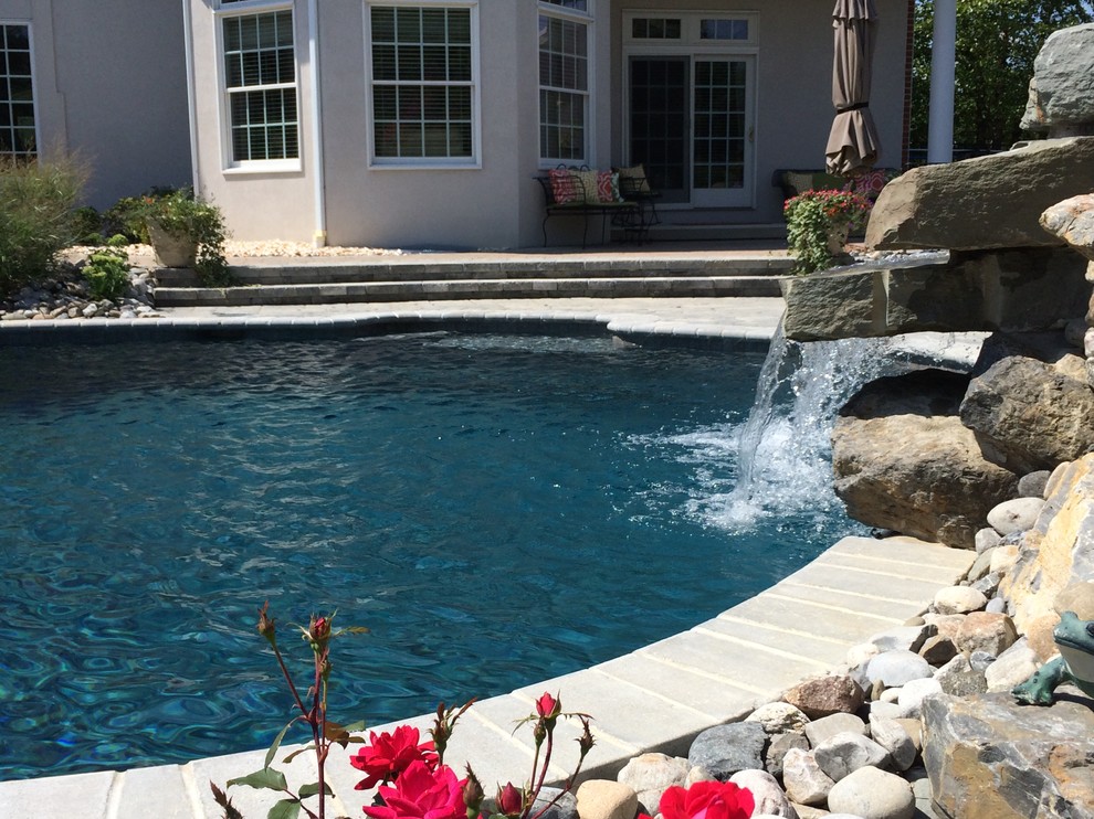 Bethlehem Township pool and spa with waterfall and sunshelf