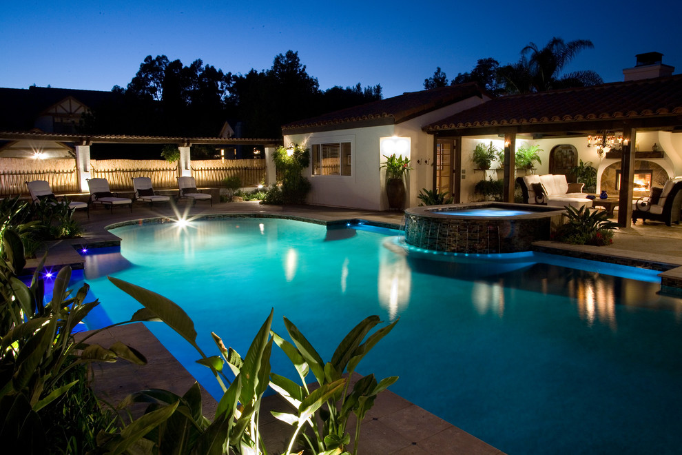 Example of a large classic backyard custom-shaped lap hot tub design in San Diego